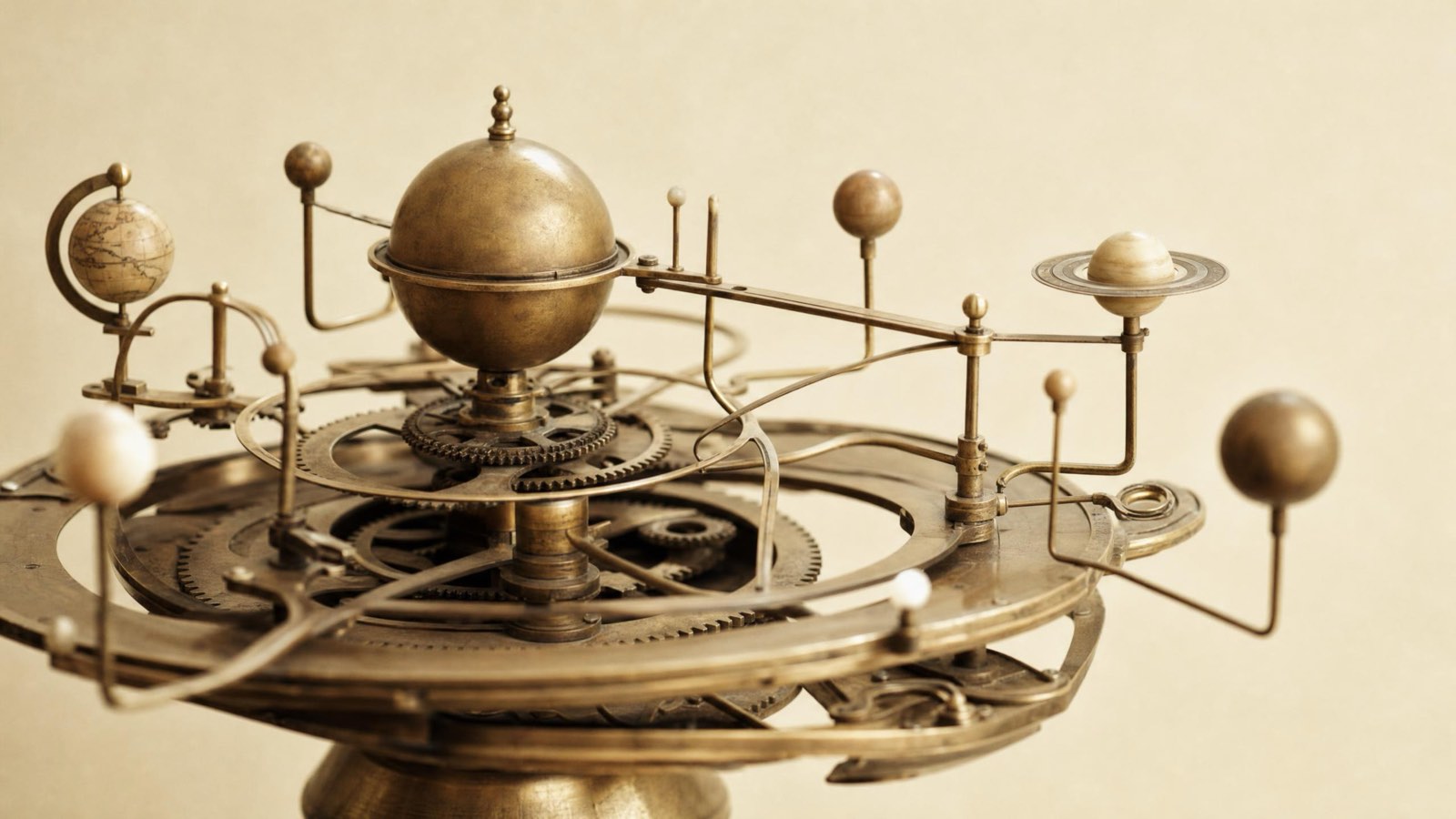 An antique brass orrery with planets on geared arms